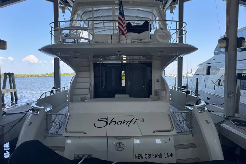  Yacht Photos Pics Luxury 2006 Marquis 65 yacht docked, rear view with American flag, New Orleans.