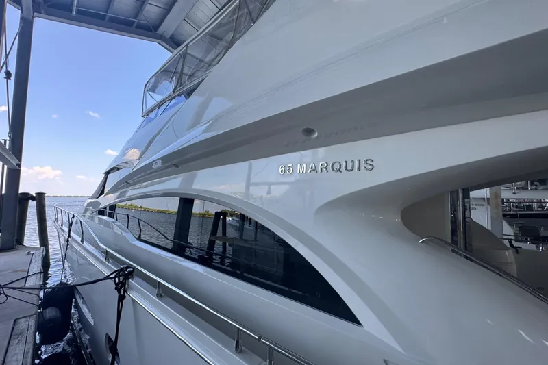  Yacht Photos Pics Luxury 2006 Marquis 65 yacht docked under a covered marina.