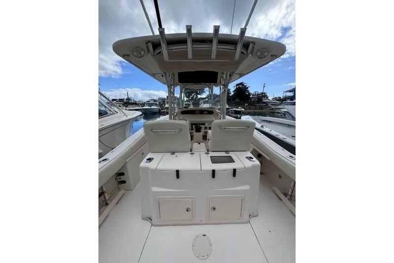  Yacht Photos Pics 2011 Grady-White Canyon 306 boat interior, featuring helm and seating, docked at marina.