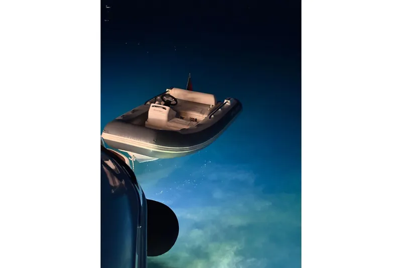 Home Office II Yacht Photos Pics 2023 Princess V60 yacht with tender in illuminated water at night.