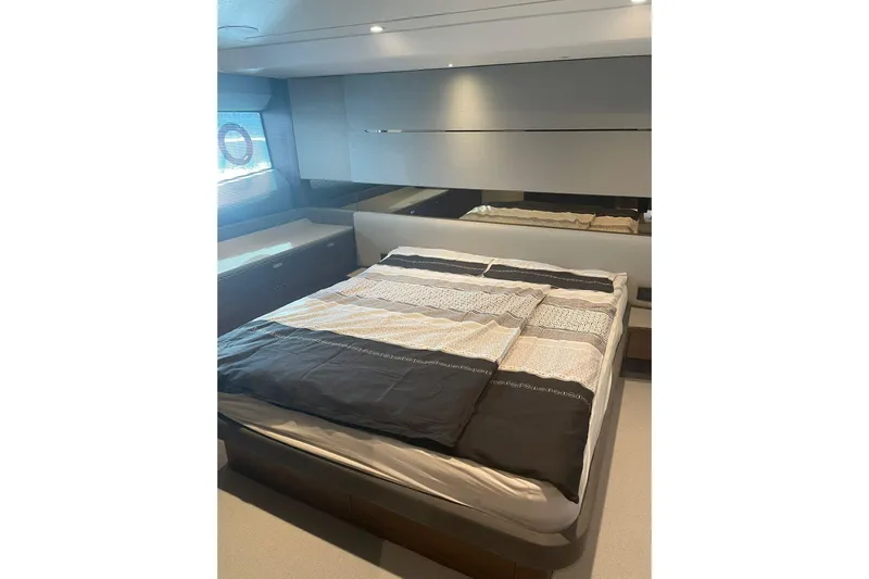 Home Office II Yacht Photos Pics Luxurious bedroom interior of 2023 Princess V60 yacht with modern design and comfortable bedding.