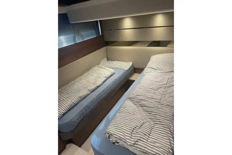 Home Office II Yacht Photos Pics 2023 Princess V60 yacht cabin with twin beds and striped bedding.