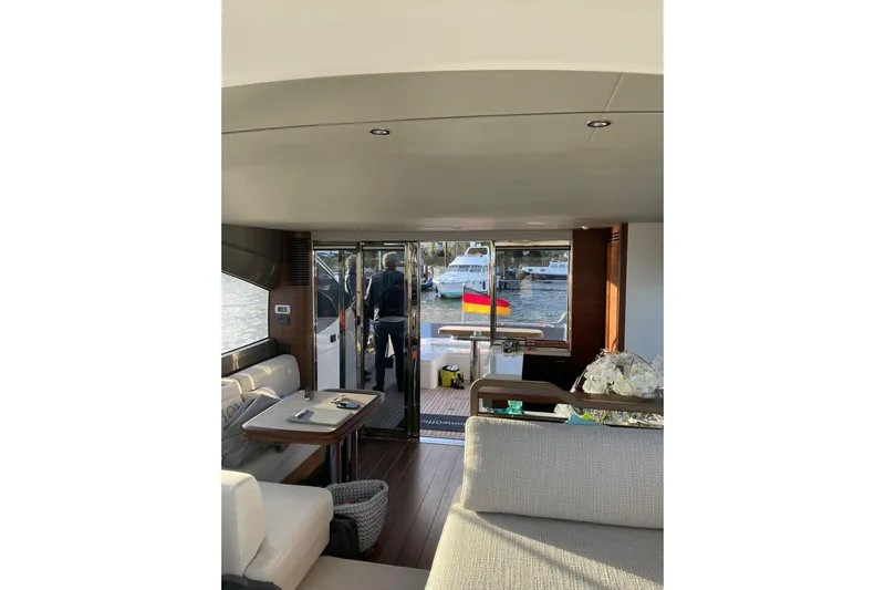 Home Office II Yacht Photos Pics Interior of 2023 Princess V60 yacht with modern furnishings and marina view.
