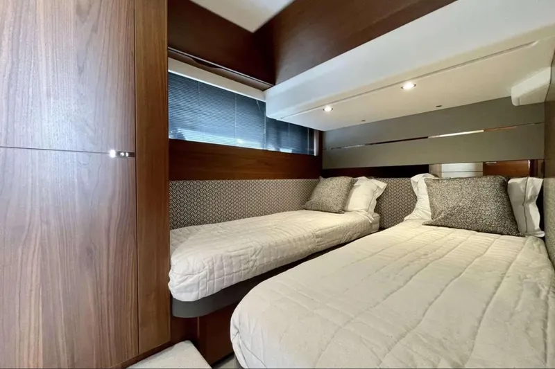 Home Office II Yacht Photos Pics Luxurious 2023 Princess V60 yacht cabin with twin beds and elegant wood finish.