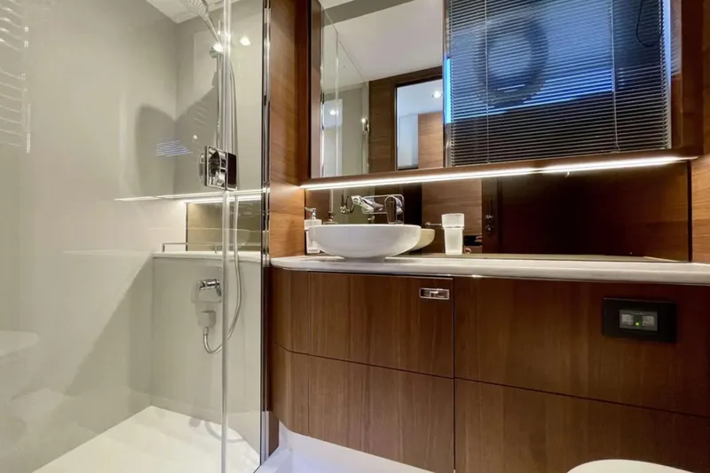 Home Office II Yacht Photos Pics Luxurious bathroom in 2023 Princess V60 yacht with modern fixtures and elegant wood cabinetry.