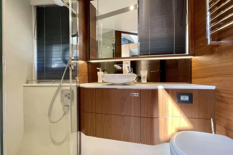 Home Office II Yacht Photos Pics Luxurious bathroom in 2023 Princess V60 yacht with modern fixtures and wood accents.