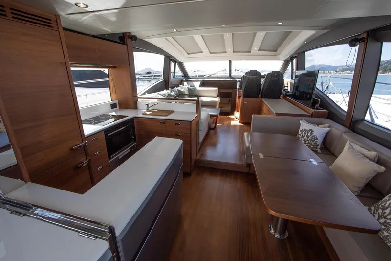 Home Office II Yacht Photos Pics Luxurious interior of 2023 Princess V60 yacht with modern kitchen and seating area.