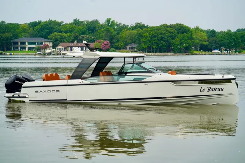  Yacht Photos Pics 2023 Saxdor 320 GTO boat on calm water, surrounded by lush greenery.