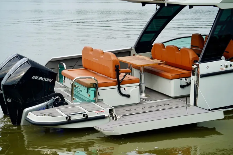  Yacht Photos Pics 2023 Saxdor 320 GTO boat with Mercury engines, featuring orange seating and a wooden table.