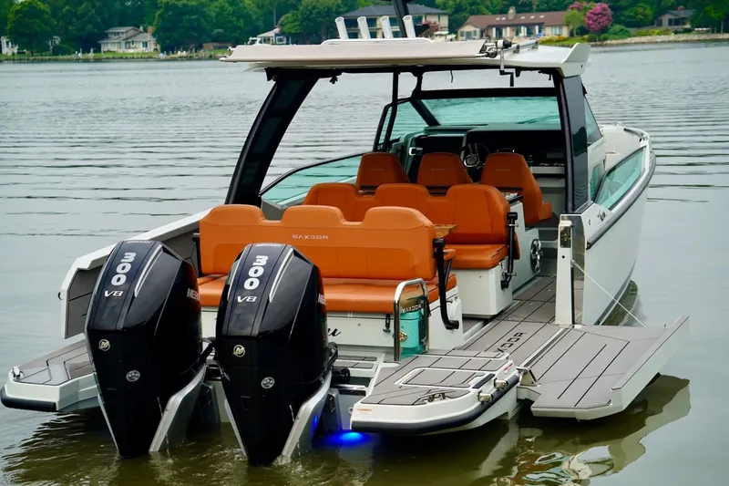  Yacht Photos Pics 2023 Saxdor 320 GTO boat with dual 300 V8 engines on a calm lake.