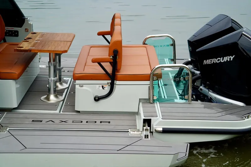  Yacht Photos Pics 2023 Saxdor 320 GTO boat interior with seating, table, and Mercury engine.