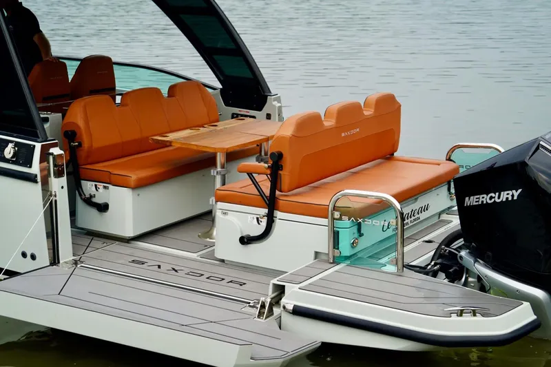  Yacht Photos Pics 2023 Saxdor 320 GTO boat with orange seating and Mercury engine on calm water.