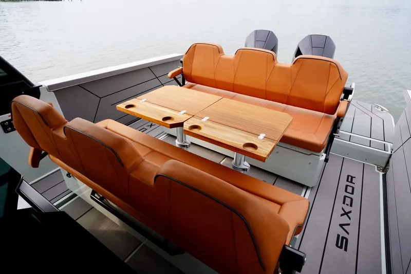  Yacht Photos Pics Luxurious seating area on 2023 Saxdor 320 GTO boat with wooden table and leather seats.