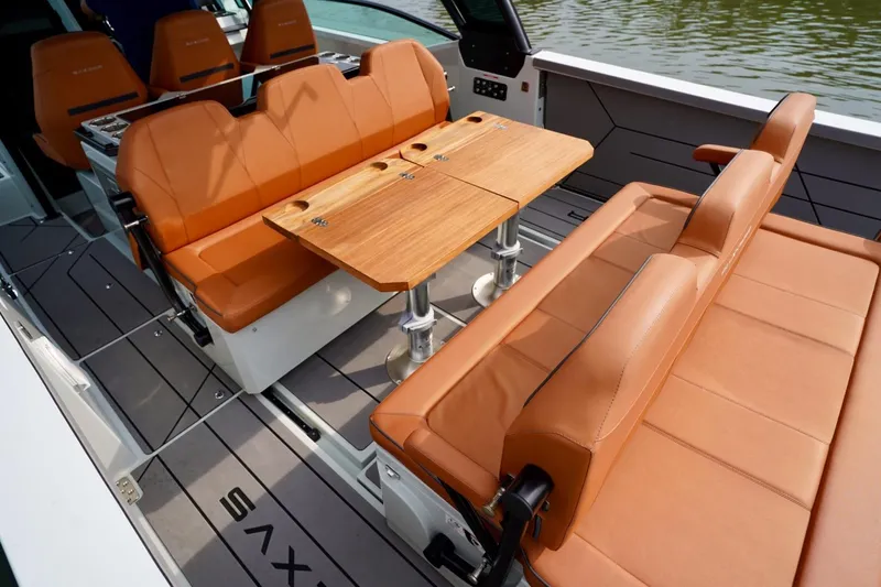  Yacht Photos Pics Luxurious seating area on 2023 Saxdor 320 GTO boat with elegant wooden table.