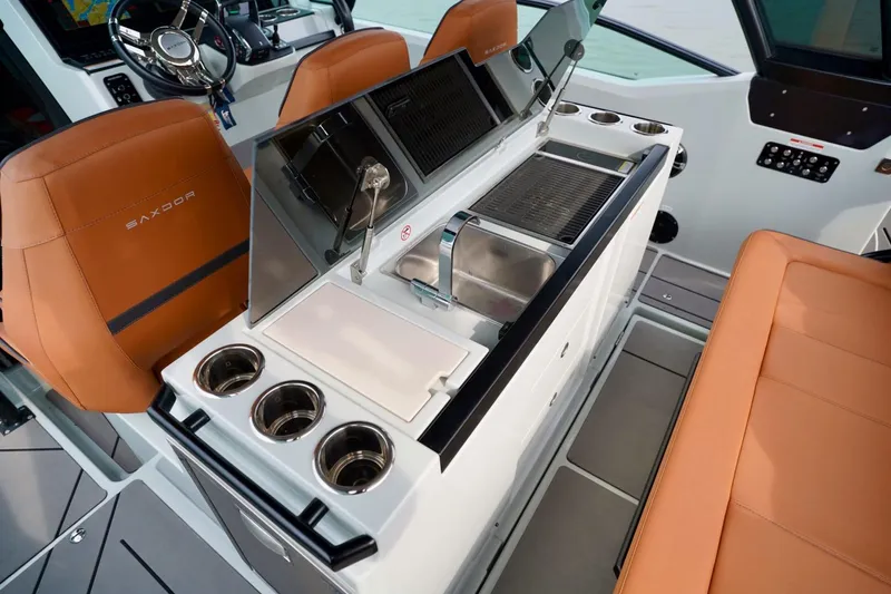  Yacht Photos Pics 2023 Saxdor 320 GTO interior with orange seats, modern helm, and sleek kitchen area.