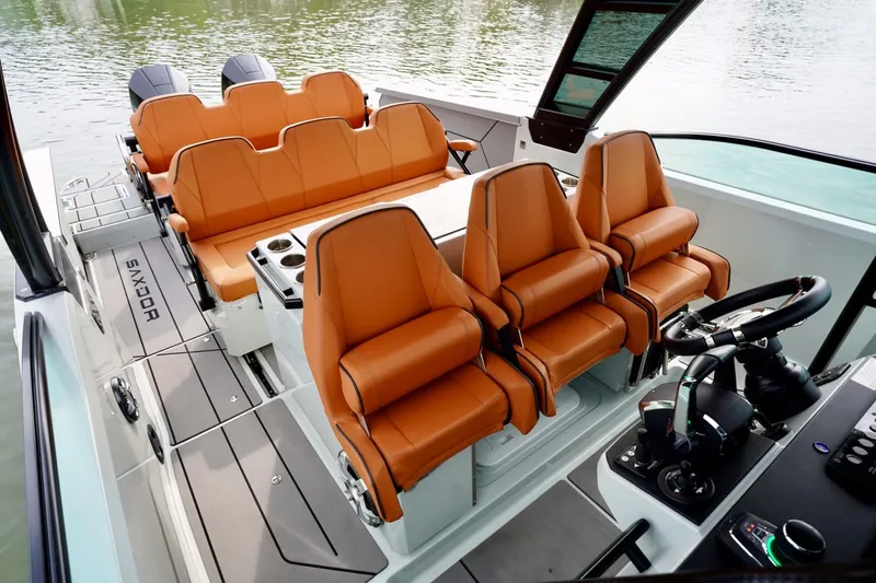  Yacht Photos Pics 2023 Saxdor 320 GTO boat interior with orange seats and modern controls.