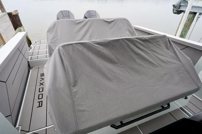  Yacht Photos Pics 2023 Saxdor 320 GTO boat with covered seating and twin engines at a dock.