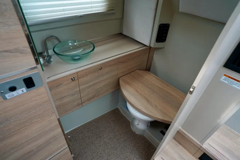  Yacht Photos Pics 2023 Saxdor 320 GTO interior bathroom with wooden cabinetry and glass sink.