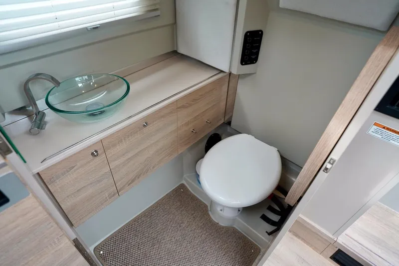  Yacht Photos Pics Modern bathroom in 2023 Saxdor 320 GTO boat with glass sink and compact toilet.