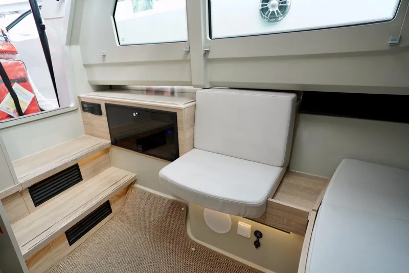  Yacht Photos Pics 2023 Saxdor 320 GTO interior with modern seating and wooden steps.