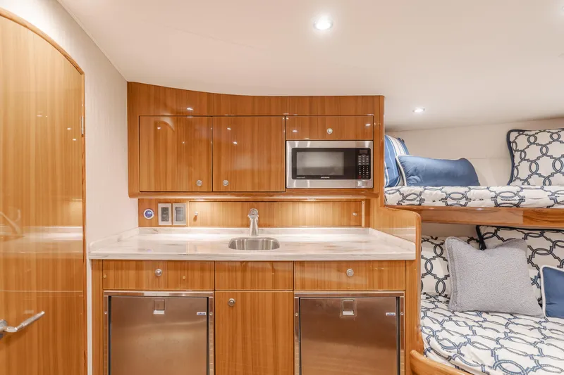 Champion Yacht Photos Pics 2022 Viking 38 Open Billfish interior with kitchenette, microwave, and bunk beds.