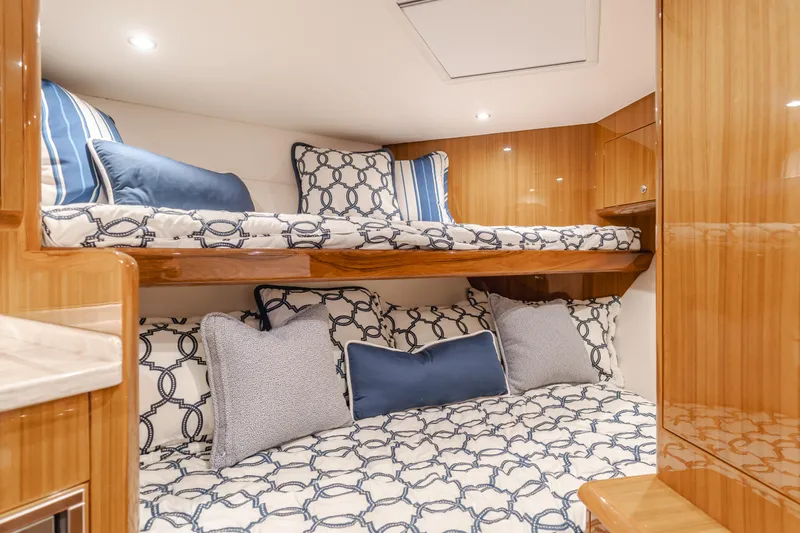Champion Yacht Photos Pics Luxurious cabin interior of 2022 Viking 38 Open Billfish with stylish bedding and wood finish.