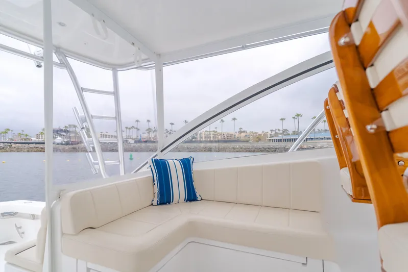 Champion Yacht Photos Pics 2022 Viking 38 Open Billfish interior with white seating and blue-striped pillow.