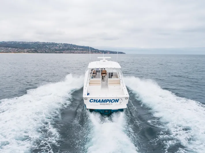 Champion Yacht Photos Pics 2022 Viking 38 Open Billfish cruising on open water, rear view.