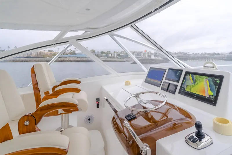 Champion Yacht Photos Pics 2022 Viking 38 Open Billfish helm with modern navigation displays and luxurious seating.