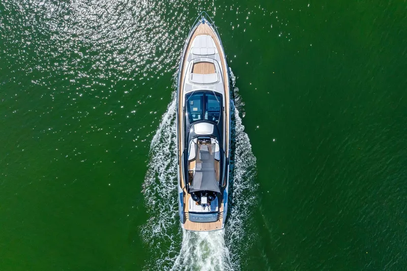 Dreaming Yacht Photos Pics Aerial view of 2023 Riva 76 PERSEO Super yacht cruising on green water.