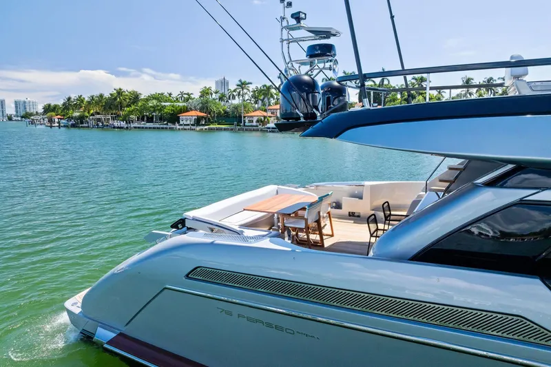 Dreaming Yacht Photos Pics Luxury 2023 Riva 76 PERSEO Super yacht docked by tropical waterfront homes.