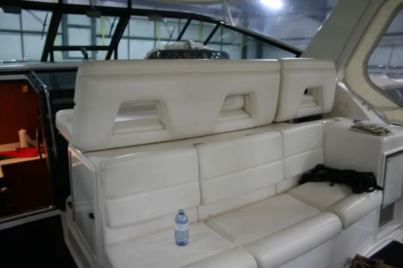  Yacht Photos Pics 2001 Tiara Yachts 4000 Express interior with white seating and a water bottle.