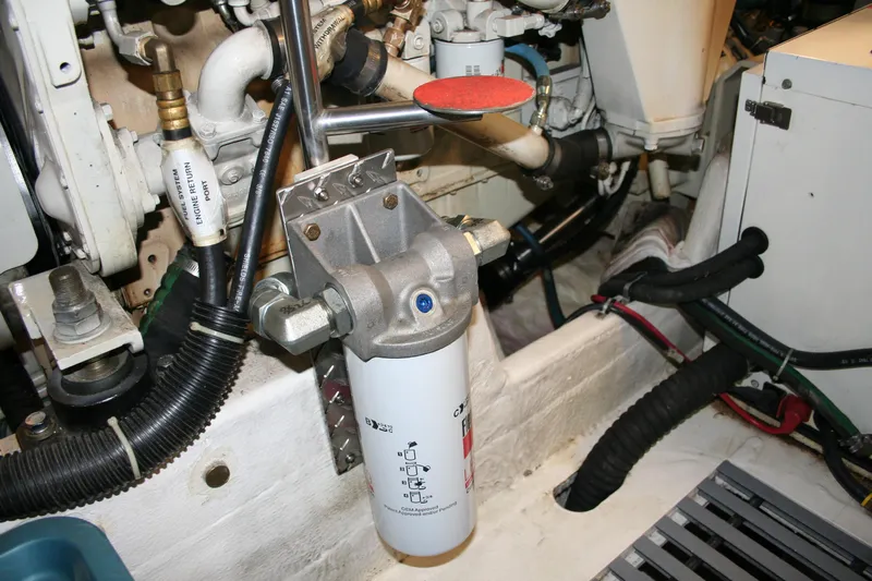  Yacht Photos Pics Engine room of 2001 Tiara Yachts 4000 Express, showcasing mechanical components and filter system.