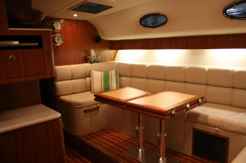  Yacht Photos Pics Luxurious interior of 2001 Tiara Yachts 4000 Express with plush seating and wooden accents.