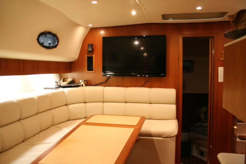 Yacht Photos Pics Luxurious interior of 2001 Tiara Yachts 4000 Express with plush seating and TV.