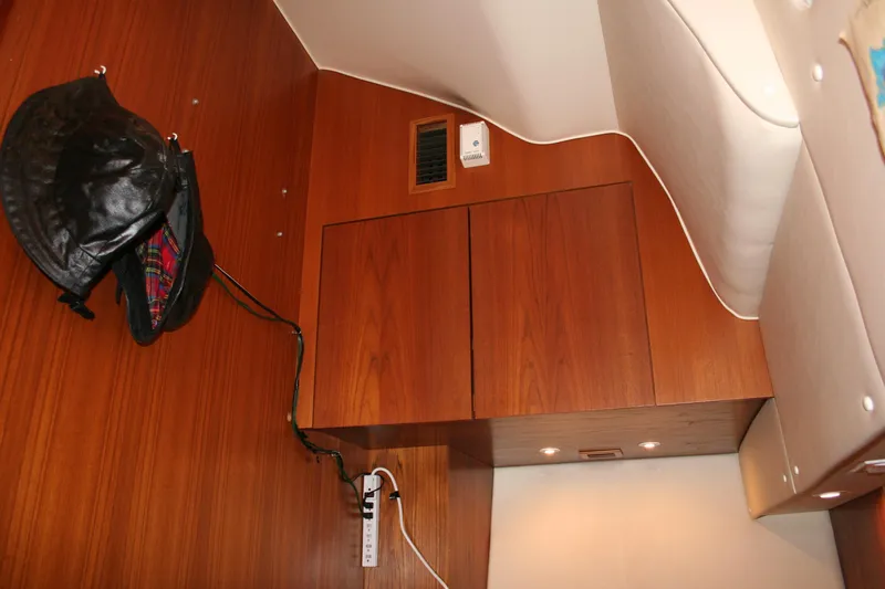  Yacht Photos Pics Interior of 2001 Tiara Yachts 4000 Express with wooden cabinetry and leather jacket hanging.