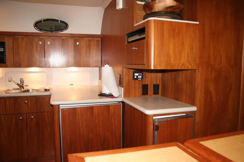  Yacht Photos Pics 2001 Tiara Yachts 4000 Express kitchen with wooden cabinetry and modern appliances.