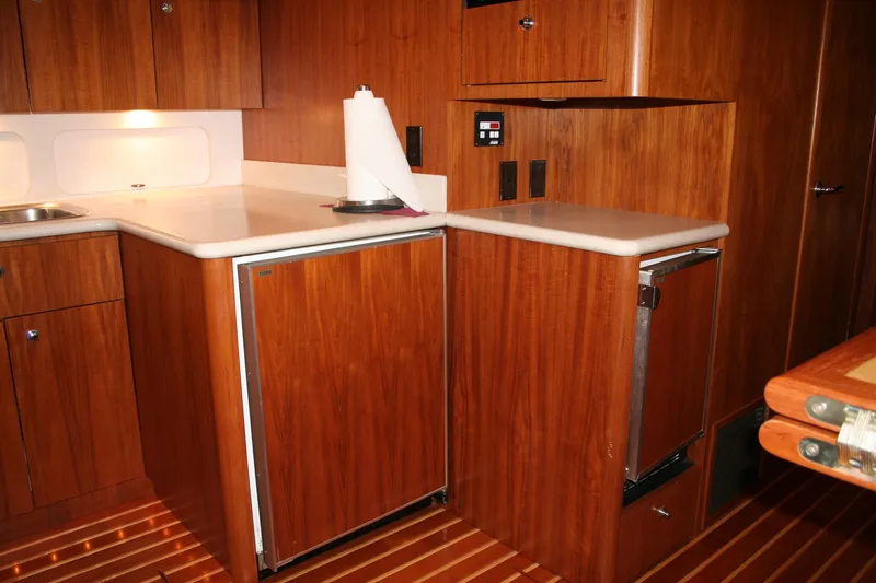  Yacht Photos Pics 2001 Tiara Yachts 4000 Express galley with wood cabinetry and modern appliances.
