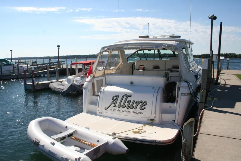  Yacht Photos Pics 2001 Tiara Yachts 4000 Express docked at marina, sunny day, inflatable boat attached.