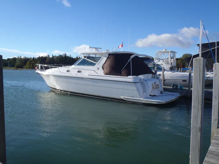  Yacht Photos Pics 2001 Tiara Yachts 4000 Express docked in a marina under clear blue skies.