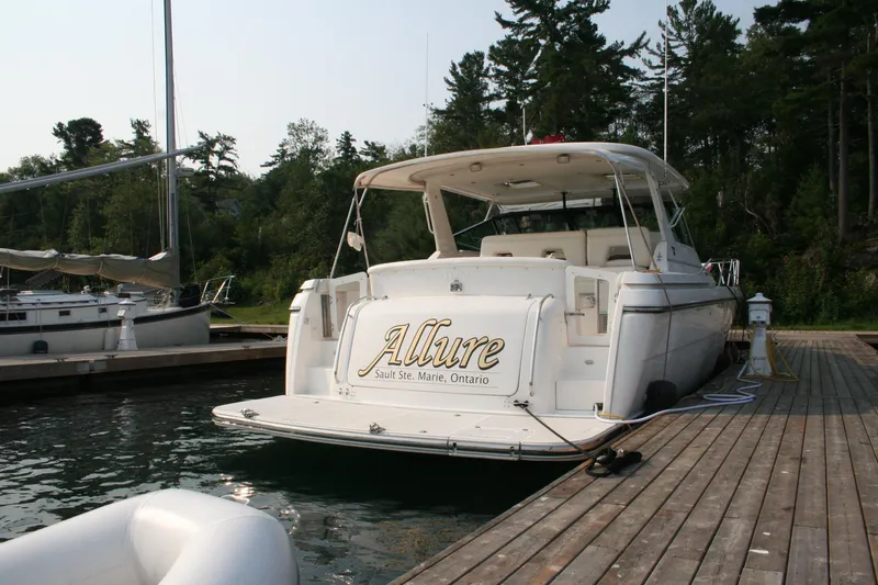  Yacht Photos Pics 2001 Tiara Yachts 4000 Express docked, rear view, with "Allure" name visible.