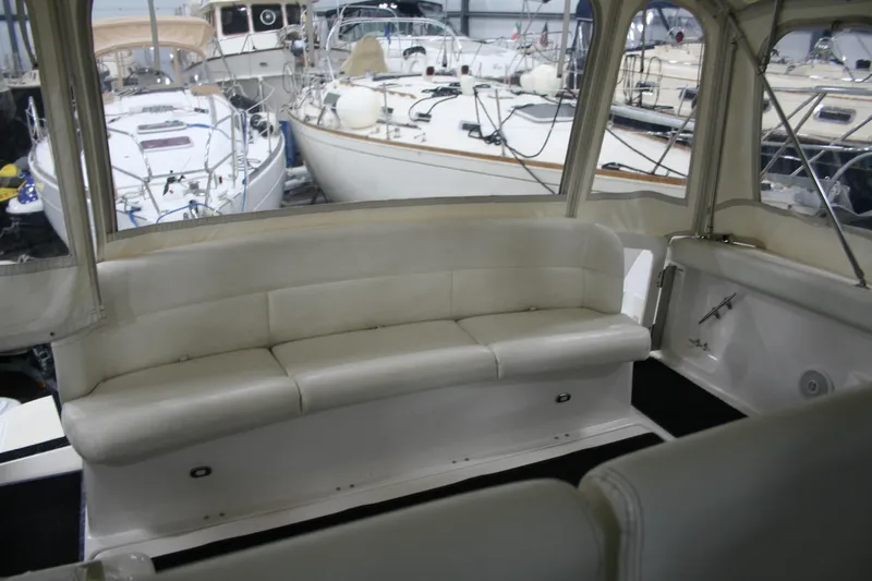  Yacht Photos Pics 2001 Tiara Yachts 4000 Express interior with white seating, docked among other boats.