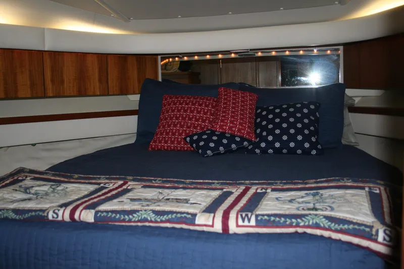 Yacht Photos Pics Luxurious cabin interior of 2001 Tiara Yachts 4000 Express with cozy bedding and decorative pillows.