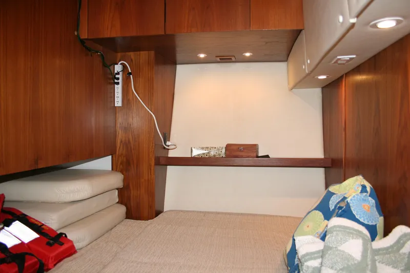  Yacht Photos Pics 2001 Tiara Yachts 4000 Express cabin interior with wood paneling and cozy bedding.