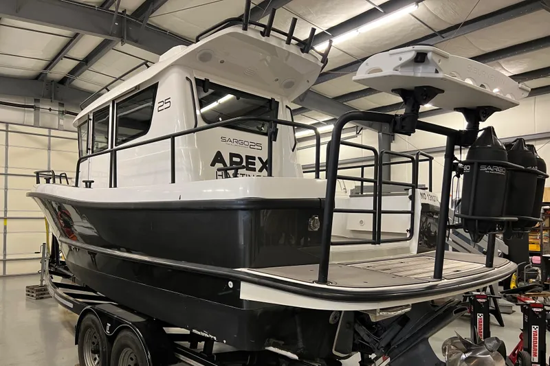  Yacht Photos Pics 2021 Sargo 25 boat in a warehouse on a trailer.