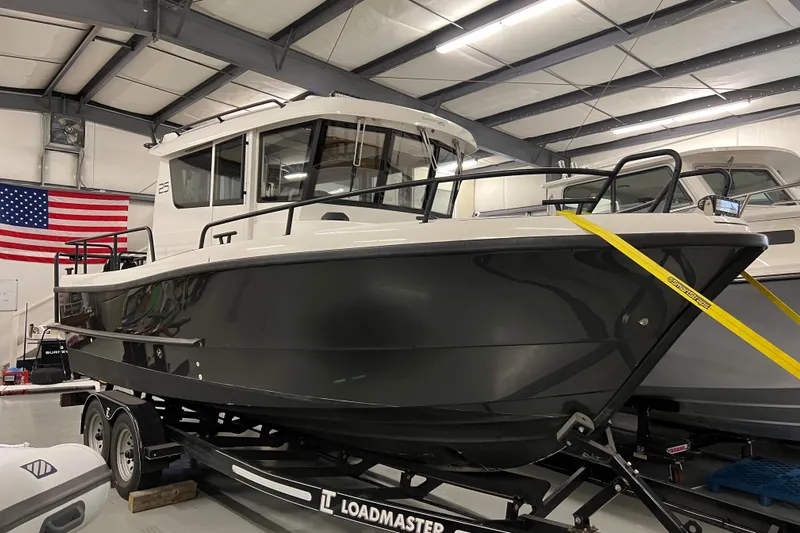 Yacht Photos Pics 2021 Sargo 25 boat on Loadmaster trailer in indoor storage facility.