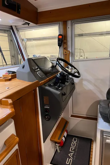  Yacht Photos Pics Interior helm of 2021 Sargo 25 boat with steering wheel and control panel.