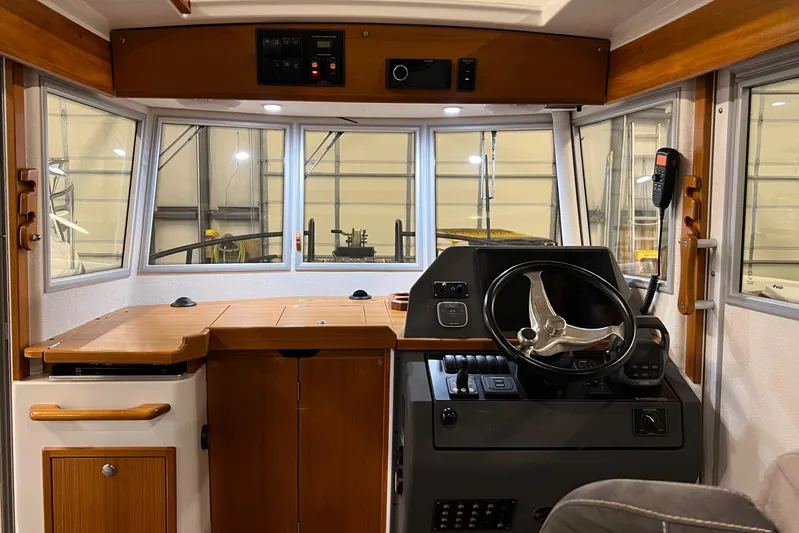  Yacht Photos Pics Interior helm of 2021 Sargo 25 boat with wooden accents and modern controls.