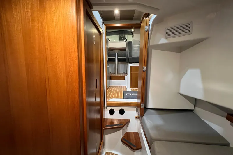  Yacht Photos Pics Interior cabin of 2021 Sargo 25 boat with wooden finishes and seating area.