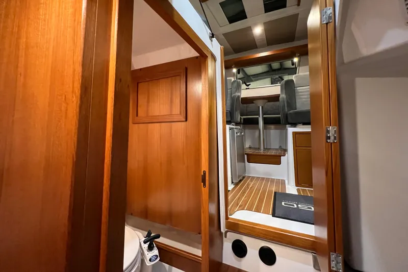  Yacht Photos Pics Interior of 2021 Sargo 25 boat with wooden finishes and modern seating.